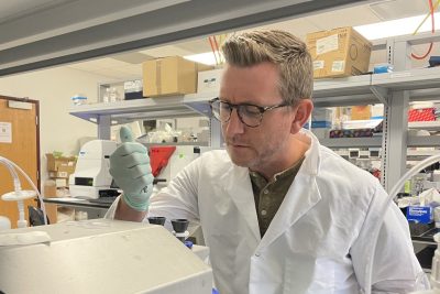 A professor working at a lab bench