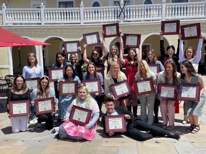 A group of Virginia Tech Nutrition and Dietetics students stand together for a group photo while holding framed certificates