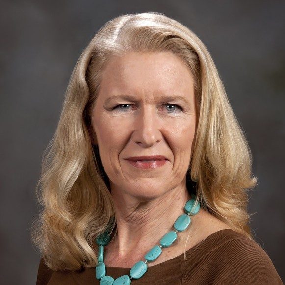 A Virginia Tech HNFE faculty member sits inside a studio for a professional headshot.