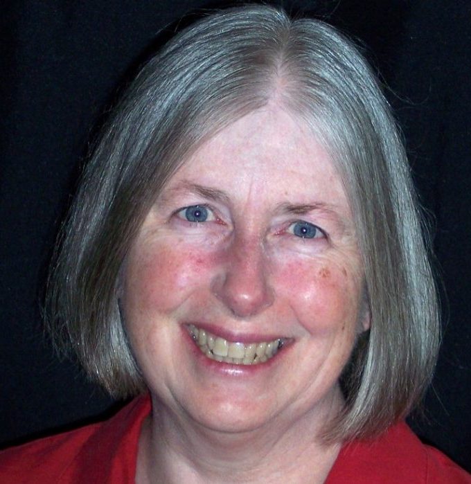 A Virginia Tech HNFE faculty member sits inside a studio for a professional headshot.