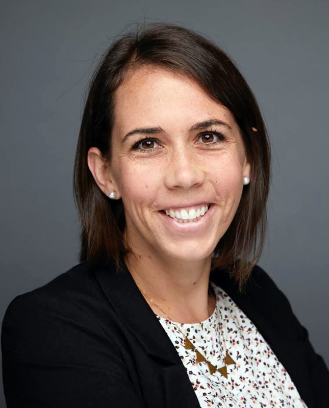 A Virginia Tech HNFE faculty member sits inside a studio for a professional headshot.