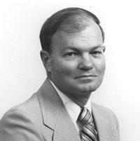 A Virginia Tech HNFE faculty member sits inside a studio for a professional headshot.