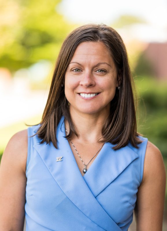 A Virginia Tech HNFE faculty member stands outside for a photo.