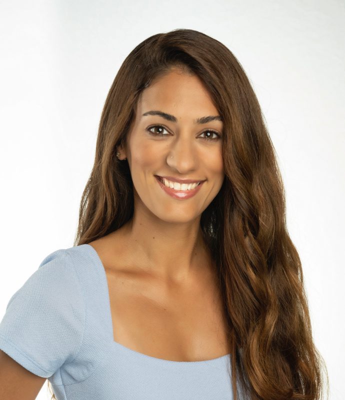 A Virginia Tech HNFE adjunct faculty member stands inside a studio for a professional photo.