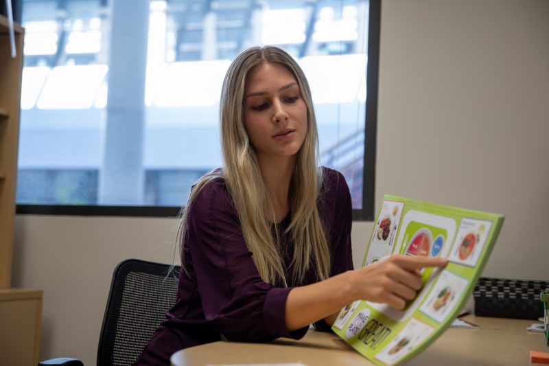 A student pointing at something during a nutrition counseling session